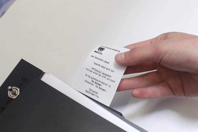 Printed receipt emerging from the station, summarizing the participantās choices and flagging any valueādecision misalignments.